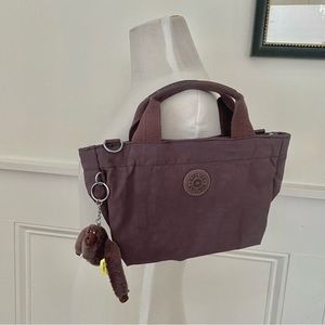 Kipling Dusty Rose Handbag with Nanny Monkey. Never used 12” W x 7 “H x 6” D.